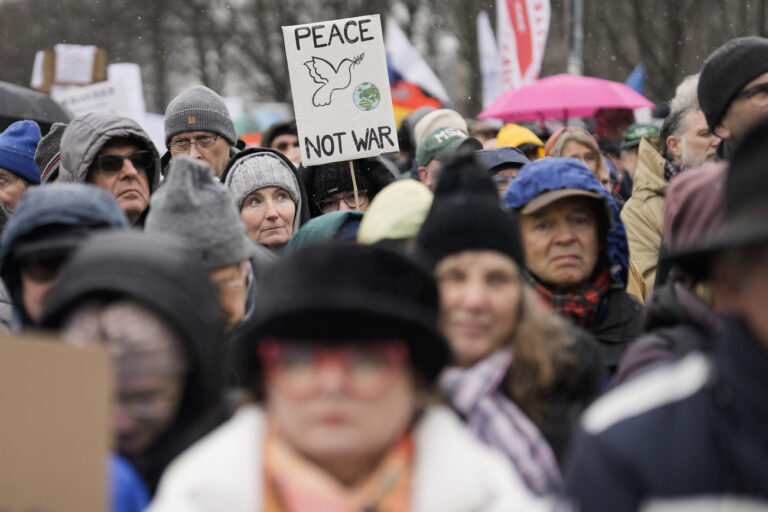 People attend a demonstration supporting a so called 'Manifesto for Peace' in Berlin, Saturday, Germany, Feb. 25, 2023. The demonstrators demand that Germany stop supplying weapons to Kiev and start negotiations with Russia. (AP Photo/Markus Schreiber)