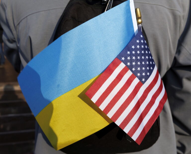 epa10493243 A demonstrator displays the Ukrainian and United States flags during the 'Stand with Ukraine Rally,' hosted by the Ukrainian Cultural Center of New England on Copley Square in Boston, Massachusetts, USA, 26 February 2023. Russian troops entered Ukrainian territory on 24 February 2022, starting a conflict that has provoked destruction and a humanitarian crisis. One year on, fighting continues in many parts of the country. EPA/CJ GUNTHER