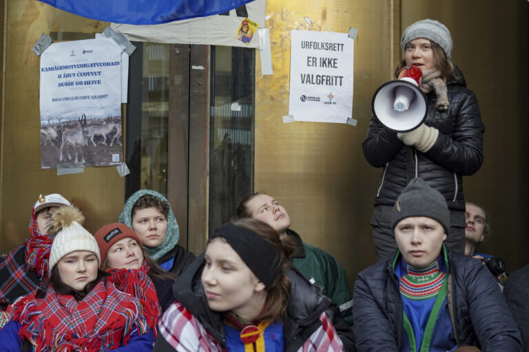 Greta Thunberg, right, joins the campaigners from Nature and Youth and Norwegian Samirs Riksforbund Nuorat who are blocking the entrances to the Ministry of Oil and Energy in Oslo Monday morning, Feb. 27, 2023. The reason for the action is that the wind turbines at Fosen, which the Supreme Court has said are illegal, have not been demolished. (Ole Berg-Rusten/NTB Scanpix via AP)