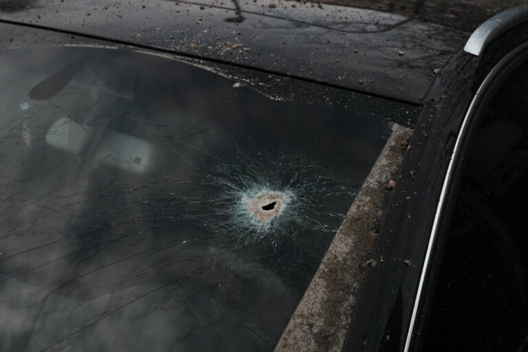 A scharpnel hole covers the windshield of a car near the area where a rocket attack took place, in Kyiv, Ukraine, Thursday, March 9, 2023. Russia unleashed a massive missile barrage targeting across Ukraine early Thursday, hitting residential buildings and killing an unconfirmed number of people in the largest such attack in three weeks. (AP Photo/Thibault Camus)