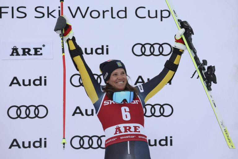 Sweden's Sara Hector celebrates on the podium after taking third place in an alpine ski, women's World Cup giant slalom race, in Are, Sweden, Friday, March 10, 2023. (AP Photo/Alessandro Trovati)