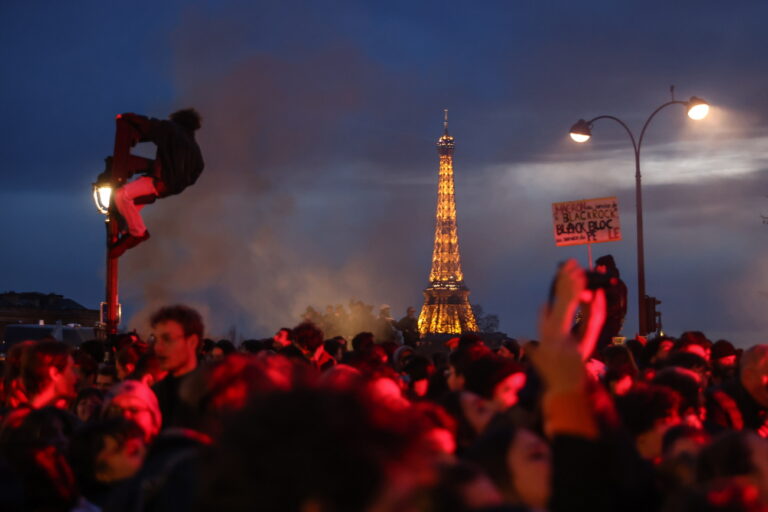 epa10527440 People demonstrate near the National Assembly after the French National Assembly vote on the government's proposed pension reform law, as Eiffel Tower in the background, in Paris, France, 16 March 2023. People demonstrated outside the French Parliament after France's prime minister used the controversial Article 49 paragraph 3 (49.3) of the Constitution on the vote of the pension reform law to raise the retirement age from 62 to 64 by 2030 after the Senate voted in favor. EPA/Mohammed Badra