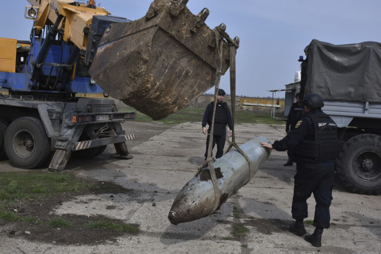 Emergency workers remove a FAB-500 unexploded Russian air bomb in the town of Preobrazhenka, Zaporizhzhia region, Ukraine, Thursday, March 23, 2023. (AP Photo/Andriy Andriyenko)