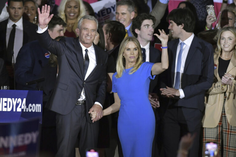 Robert F. Kennedy Jr. and wife Cheryl Hines wave with family members onstage at an event where announced his run for president on Wednesday, April 19, 2023, at the Boston Park Plaza Hotel, in Boston. (AP Photo/Josh Reynolds)