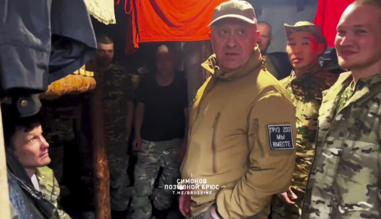 In this handout image taken from a video released by Prigozhin Press Service on Friday, May 26, 2023, head of Wagner Group military company Yevgeny Prigozhin, centre, visits a rear camp of a Wagner unit at an undisclosed location. (Prigozhin Press Service via AP)