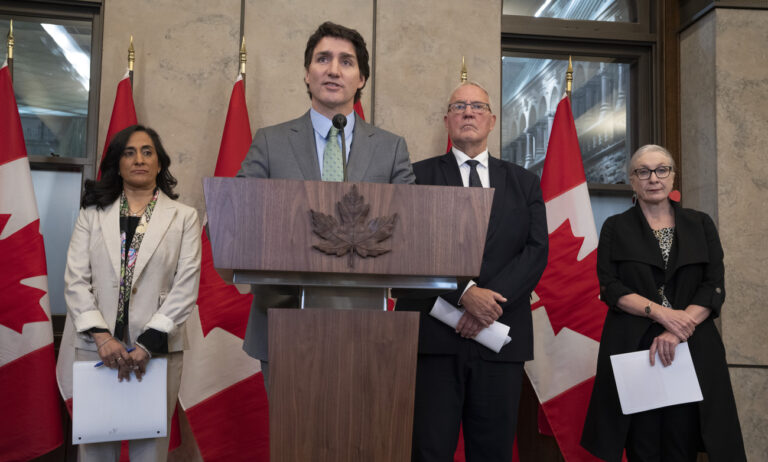 Defence Minister Anita Anand, Emergency Preparedness Minister Bill Blair and Indigenous Services Minister Patty Hajdu look on as Prime Minister Justin Trudeau speaks during a news conference, in Ottawa, Wednesday, June 7, 2023. Smoke from Canadian wildfires poured into the U.S. East Coast and Midwest on Wednesday, covering the capitals of both nations in an unhealthy haze, holding up flights at major airports and prompting people to fish out pandemic-era face masks. (Adrian Wyld/The Canadian Press via AP)