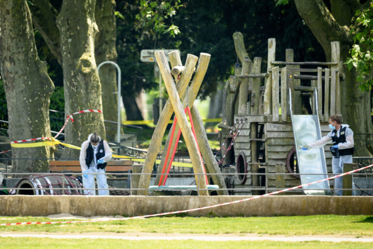 France's police gather in a playground at the scene of a knife attack in Annecy, France, Thursday, June 8, 2023. The Prefecture of Haute-Savoie confirmed on 08 June that a man had carried out an attack in the Paquier d'Annecy park area, injuring at least four children and an adult. (KEYSTONE/Jean-Christophe Bott)