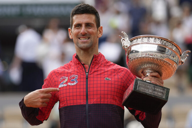 Serbia's Novak Djokovic points at 23 on his garment as he celebrates winning the men's singles final match of the French Open tennis tournament against Norway's Casper Ruud in three sets, 7-6, (7-1), 6-3, 7-5, at the Roland Garros stadium in Paris, Sunday, June 11, 2023. Djokovic won his record 23rd Grand Slam singles title, breaking a tie with Rafael Nadal for the most by a man. (AP Photo/Thibault Camus)