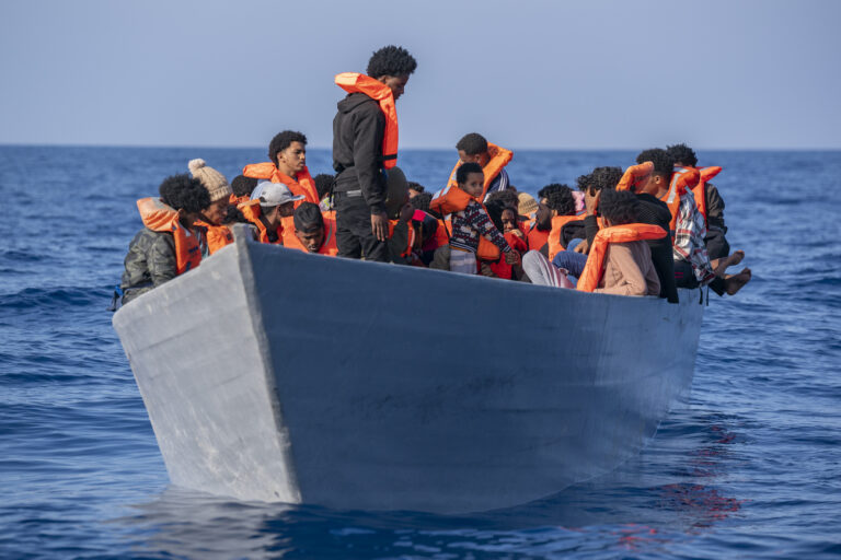 Migrants from Eritrea, Libya and Sudan crowd the deck of a wooden boat as they wait to be assisted by aid workers of the Spanish NGO Open Arms, in the Mediterranean sea, about 30 miles north of Libya, Saturday, June 17, 2023. (AP Photo/Joan Mateu Parra)