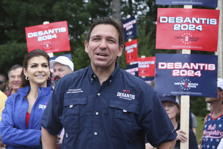 Republican presidential candidate and Florida Gov. Ron DeSantis and his wife Casey, walk in the July 4th parade, Tuesday, July 4, 2023, in Merrimack, N.H. (AP Photo/Reba Saldanha)