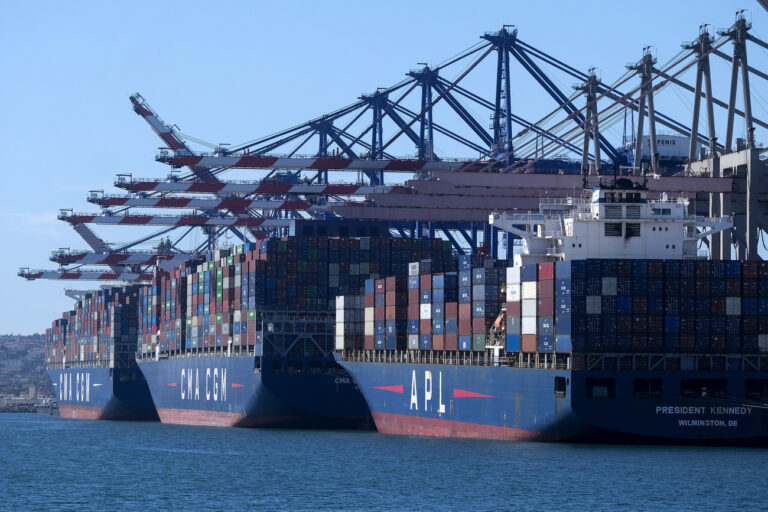 FILE - Cargo containers sit stacked on ships at the Port of Los Angeles, Wednesday, Oct. 20, 2021 in San Pedro, Calif. Maritime nations are finalizing a plan Thursday, July 6, 2023, to slash emissions from the shipping industry to net zero by around 2050 but experts warn the deal falls well short of what's needed to prevent climate catastrophe. (AP Photo/Ringo H.W. Chiu, File)