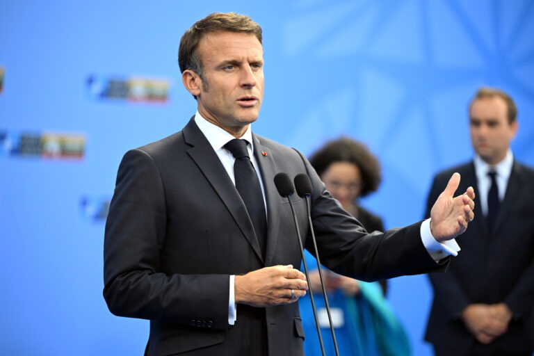 epa10738987 France's President Emmanuel Macron speaks to the media as he arrives to attend the NATO summit in Vilnius, Lithuania, 11 July 2023. The North Atlantic Treaty Organization (NATO) Summit will take place in Vilnius on 11 and 12 July 2023 with the alliance's leaders expected to adopt new defense plans. EPA/FILIP SINGER