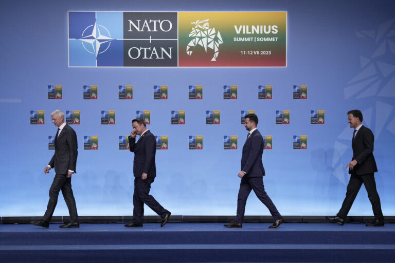 Latvia's Prime Minister Krisjanis Karins, left, and Luxembourg's Prime Minister Xavier Bettel, second left, walk on the podium prior to a group photo at a NATO summit in Vilnius, Lithuania, Tuesday, July 11, 2023. NATO's summit began Tuesday with fresh momentum after Turkey withdrew its objections to Sweden joining the alliance, a step toward the unity that Western leaders have been eager to demonstrate in the face of Russia's invasion of Ukraine. (AP Photo/Pavel Golovkin)