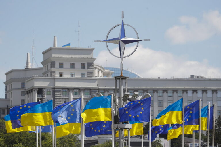 epa10741814 Ukraine's national flags and EU flags fly under the NATO logo in European Square, downton Kyiv (Kiev), Ukraine, 12 July 2023, amid the Russian invasion. The NATO logo was installed in Kyiv in 2019 in connection with the events marking 70 years since the founding of the intergovernmental military alliance. The North Atlantic Treaty Organization (NATO) Summit was held in the Lithuanian capital Vilnius on 11-12 July 2023, where NATO leaders agreed to bring Ukraine closer to NATO. The inaugural meeting of the 'NATO-Ukraine Council' took place on 12 July, where the Allies were joined by Ukrainian President Zelensky. EPA/SERGEY DOLZHENKO
