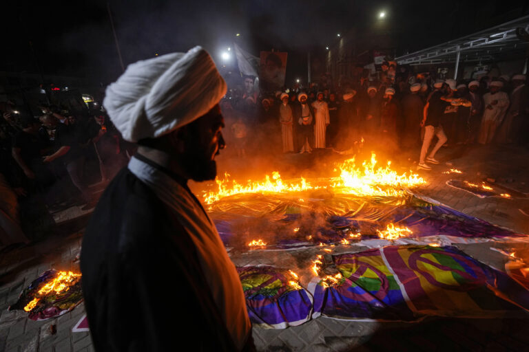 Supporters of Shiite Muslim leader Moqtada Sadr burn a rainbow flag, during a demonstration in Sadr City, in response to the burning of Quran in Sweden, Baghdad, Iraq, Wednesday, July 12, 2023. (AP Photo/Hadi Mizban)