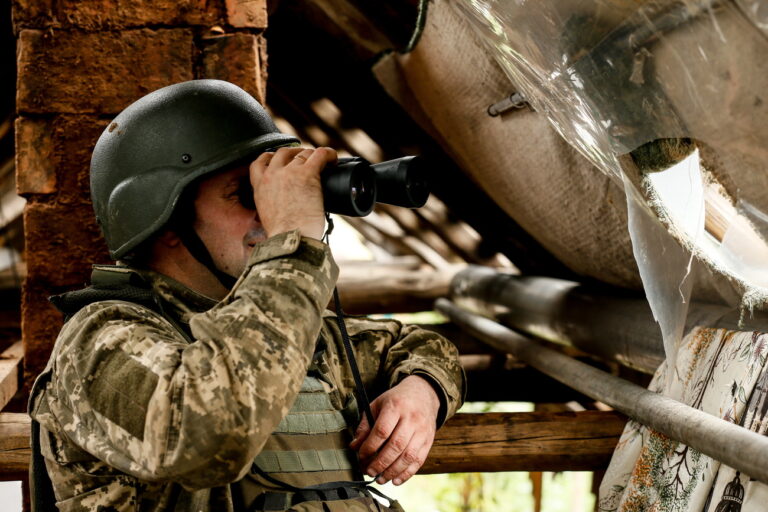epa10745996 A Ukrainian servicemen of the 24th Separate Mechanized Brigade named after 'King Danylo' using binoculars keeps watch from a position at an undisclosed location in the Donetsk region, eastern Ukraine, 14 July 2023, amid the Russian invasion. Russian troops entered Ukraine on 24 February 2022 starting a conflict that has provoked destruction and a humanitarian crisis. EPA/OLEG PETRASYUK