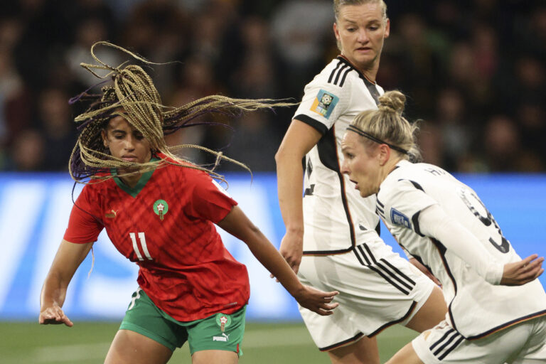 Morocco's Fatima Tagnaout, left, vies for the ball with Germany's Alexandra Popp and Svenja Huth, right, during the Women's World Cup Group H soccer match between Germany and Morocco in Melbourne, Australia, Monday, July 24, 2023. (AP Photo/Hamish Blair)