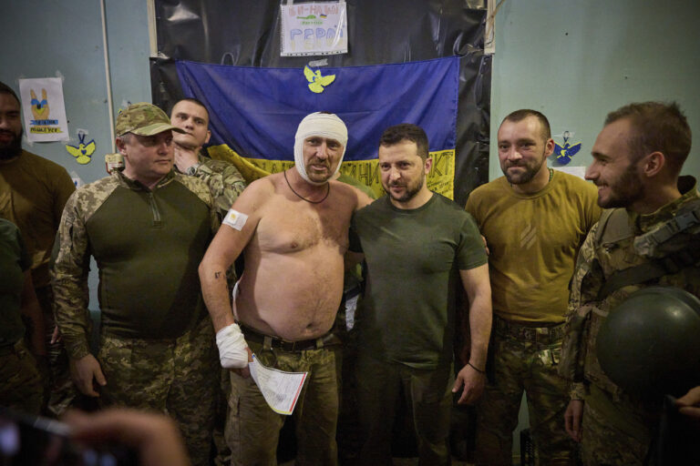 In this photo provided by the Ukrainian Presidential Press Office, Ukrainian President Volodymyr Zelenskyy poses for a photo with servicemen during his visit to the headquarters of brigades at the front line near Soledar, Donetsk region, Ukraine, Monday, Aug. 14, 2023. (Ukrainian Presidential Press Office via AP)