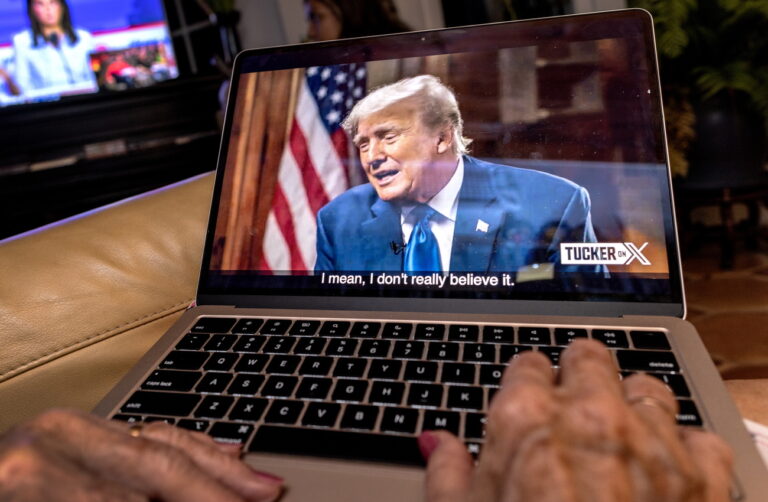 epa10816802 A viewer streams former President and Republican presidential candidate Donald Trump's interview by Tucker Carlson on the platform 'X' on their computer in Miami, Florida, USA, 23 August 2024. Trump chose not to attend the debate and instead do the interview with Carlson. The pre-recorded interview is being aired at the same time as the Republican presidential debate. EPA/CRISTOBAL HERRERA-ULASHKEVICH