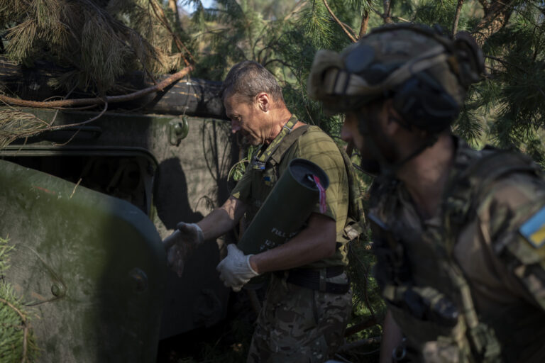 Ukrainian soldiers load a howitzer with a shell on the front line in the outskirts of Lyman, Ukraine, Tuesday, Aug. 15, 2023. Moscow's army is staging a ferocious push in northeast Ukraine designed to distract Ukrainian forces from their counteroffensive and minimize the number of troops Kyiv is able to send to more important battles in the south. (AP Photo/Bram Janssen)