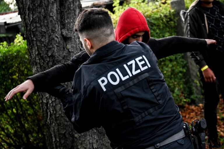 epa10913428 A German police officer checks a detained migrant during an operation to prevent illegal migration along the German-Polish border near Frost, Germany, 11 October 2023. Due to the increasing number of refugees arriving in Germany via the Balkan and Mediterranean routes, as well as war refugees from Ukraine, many refugee shelters in Germany have already reached their capacity limit. EPA/Filip Singer ATTENTION: This Image is part of a PHOTO SET
