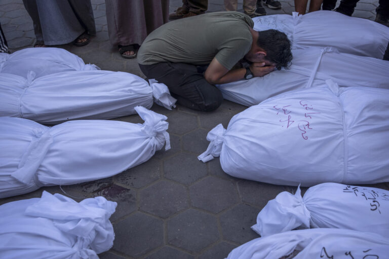 Palestinians mourn relatives killed in the Israeli bombardment of the Gaza Strip, in front of the morgue in Deir al Balah, Tuesday, Oct. 31, 2023. ( AP Photo/Fatima Shbair)