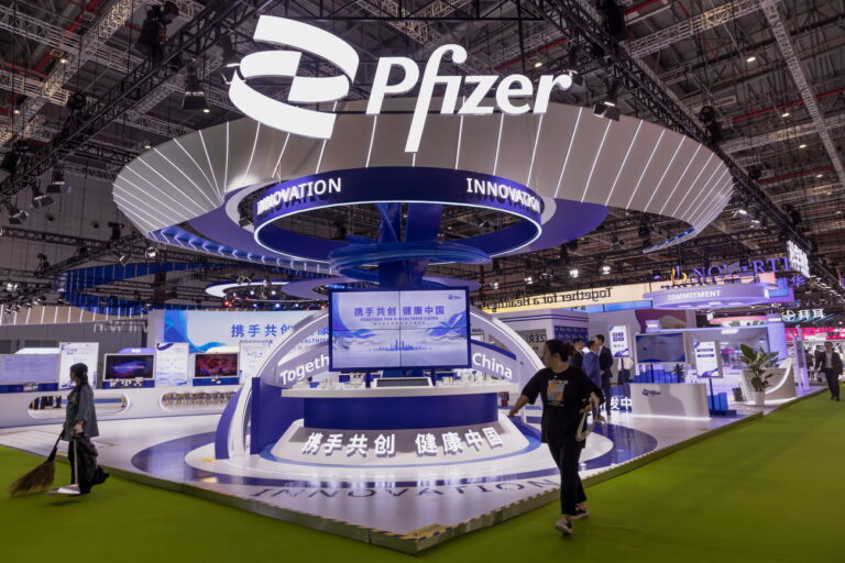 epa10958963 People walk past the Pfizer booth at the China International Import Expo in Shanghai, China, 05 November 2023. The China International Import Expo (CIIE) in Shanghai runs from 05 to 10 November 2023. EPA/ALEX PLAVEVSKI