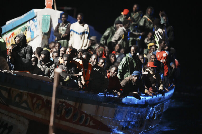 Migrants crowd a wooden boat as they are towed to the port in La Restinga on the Canary island of El Hierro on Saturday, Nov. 4, 2023. More than 32,000 migrants have landed in Spain's Canary Islands this year setting a new record for the number of irregular arrivals to the archipelago. Most migrants taking the dangerous Atlantic boat journey are leaving from Senegal. (Humberto Bilbao/Europa Press via AP)