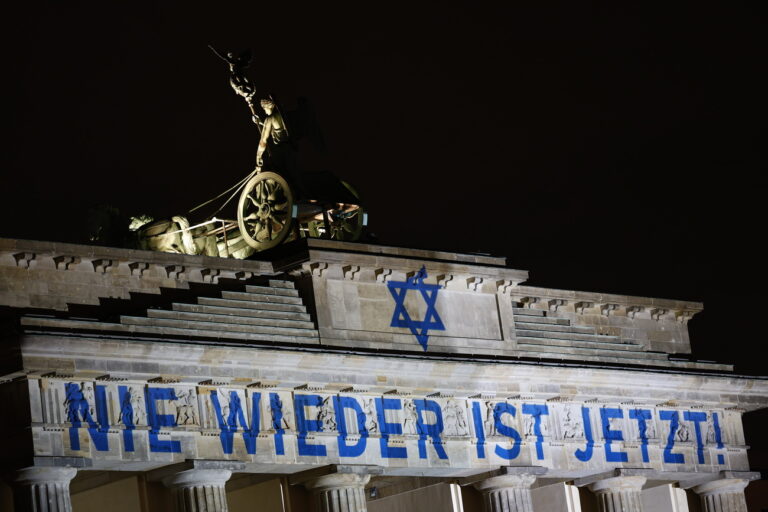 epa10967120 The slogan 'Never again is now' is projected onto the Brandenburg Gate on the 85th anniversary of the Night of Broken Glass in Berlin, Germany, 09 November 2023. The Kristallnacht, also known as Night of Broken Glass, was a pogrom against the Jewish community that took place on the night from the 09 to the 10 of November 1938. On this night, members of the Sturmabteilung SA and Schutzstaffel SS, paramilitary forces of the National Socialist German Workers' Party, attacked, ransacked and burnt Jewish-owned stores, buildings, and synagogues throughout Austria and Germany. EPA/HANNIBAL HANSCHKE