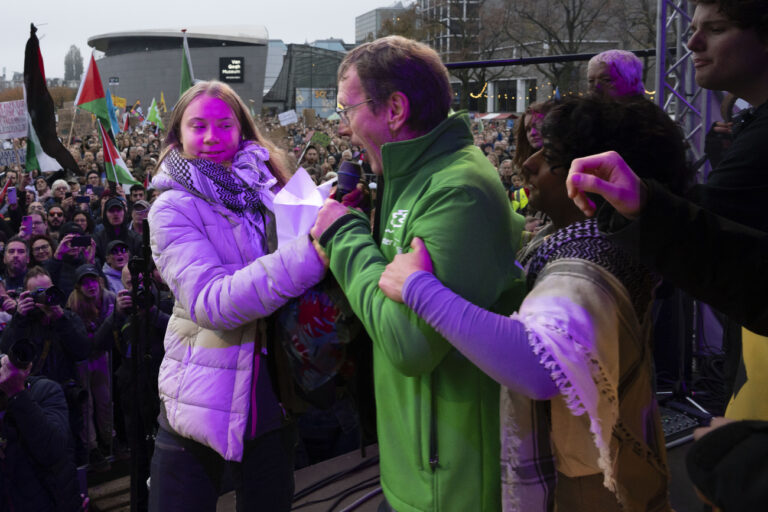 Climate activist Greta Thunberg is interrupted by a climate activist after Thunberg expressed solidarity with the Palestinians as tens of thousands of people marched through Amsterdam, Netherlands, Sunday, Nov. 12, 2023, to call for more action to tackle climate change. Thunberg was among the speakers at the march that comes 10 days before national elections in the Netherlands. (KEYSTONE/AP Photo/Peter Dejong)