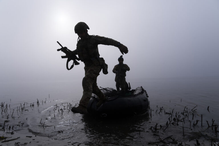 A Ukrainian serviceman jumps out of the boat on the shore of Dnipro river at the frontline near Kherson, Ukraine, Sunday Oct. 15, 2023. (AP Photo/Mstyslav Chernov)