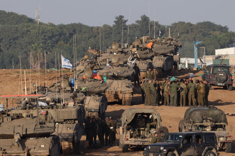 epa11007529 Israeli soldiers gather near tanks at a position near the border with the Gaza Strip, in southern Israel, 02 December 2023. The Israel Defense Forces (IDF) announced on 02 December they struck over 400 targets throughout the Gaza Strip over the past day, adding that Israeli Air Force (IAF) fighter jets struck over 50 targets in the Khan Yunis area overnight. Israeli forces hit targets in the Gaza Strip after a week-long truce expired on 01 December. More than 15,000 Palestinians and at least 1,200 Israelis have been killed, according to the Gaza Government media office and the Israel Defense Forces (IDF), since Hamas militants launched an attack against Israel from the Gaza Strip on 07 October, and the Israeli operations in Gaza and the West Bank which followed it. EPA/ATEF SAFADI