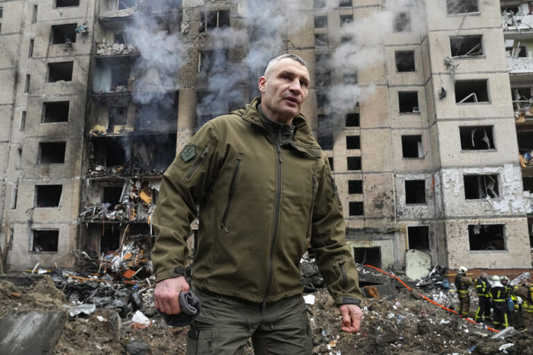Mayor of Kyiv Vitali Klitschko inspects damages as smoke rises out from a destroyed apartment building after a Russian attack in Kyiv, Ukraine, Tuesday, Jan. 2, 2024. (AP Photo/Efrem Lukatsky)