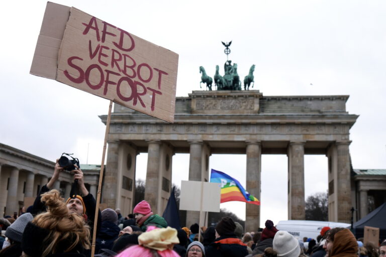 epa11076093 A protester holds up a placard reading ‘AfD ban now' during a demonstration against the far-right Alternative for Germany (AfD) party in front of the Brandenburg Gate in Berlin, Germany, 14 January 2024. The protest held under the slogan 'Defend Democracy', was organized by the Fridays for Future movement, along with other non-governmental organizations, as a reaction to revelations of the investigative journalism group Correctiv, and their report about a meeting of far-right politicians, who allegedly discussed deportation plans referred to as 'remigration', a term promoting the forced return of 'migrants' to their place of origin. EPA/CLEMENS BILAN