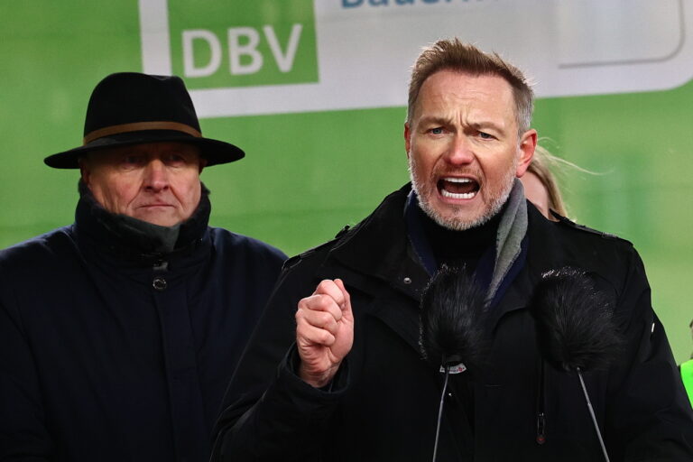 epa11079246 German Finance Minister Christian Lindner (R) speaks next to Joachim Rukwied (L), president of the German Farmers' Association, during a nationwide farmers' strike in Berlin, Germany, 15 January 2024. Farmers went on strike nationwide in Germany, in a protest against the federal government's agricultural policy. EPA/Filip Singer