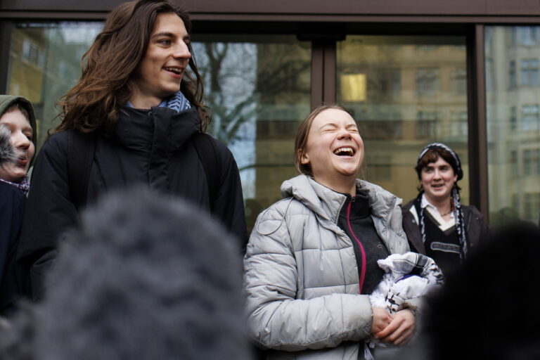 epa11120632 Swedish environmental activist Greta Thunberg (C) speaks to the press as she arrives at Westminster Magistrates Court during the lunch break in London, Britain, 02 February 2024. Thunberg has pleaded not guilty to a public order offense charge at a London protest. The campaigner was arrested on 17 October 2023 while protesting outside the Energy Intelligence Forum. EPA/TOLGA AKMEN