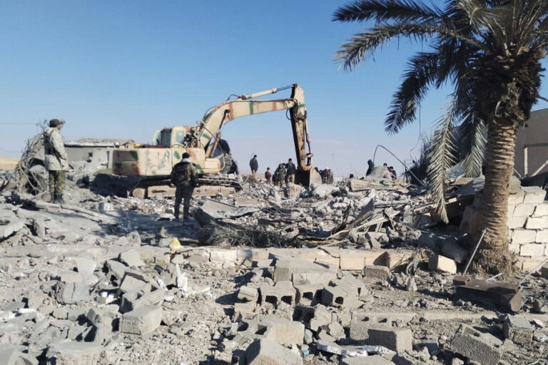Members of Iraqi Shiite Popular Mobilization Forces clean the rubble after a U.S. airstrike in al-Qaim, Iraq, Saturday, Feb. 3, 2024. The U.S. Central Command said in a statement on Friday that the U.S. forces conducted airstrikes on more than 85 targets in Iraq and Syria against Iran's Islamic Revolutionary Guards Corps and affiliated militia groups. (AP Photo/Mobilization media office)