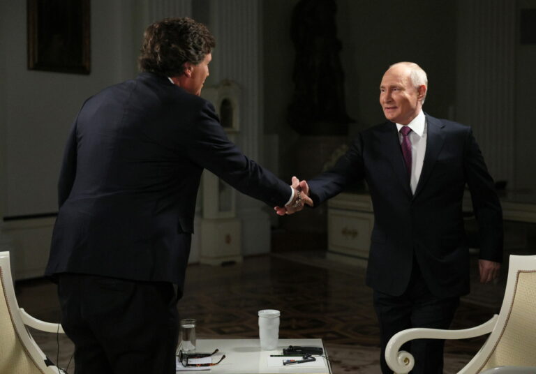 epa11138485 Russian President Vladimir Putin (R) shakes hands with US journalist Tucker Carlson prior to an interview at the Kremlin in Moscow, Russia, 09 February 2024. EPA/GAVRIIL GRIGOROV/SPUTNIK/KREMLIN POOL MANDATORY CREDIT