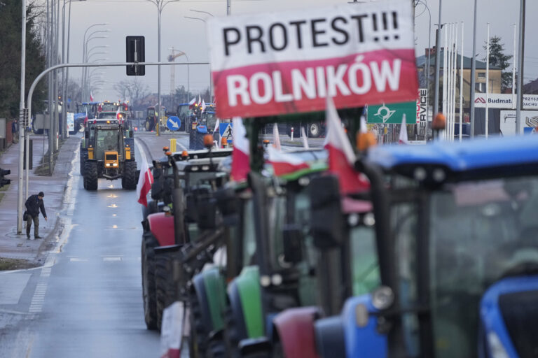 Polish farmers drive tractors in a convoy in Minsk Mazowiecki, Poland, on Tuesday Feb. 20, 2024, as they intensify a nationwide protest against the import of Ukrainian foods and European Union environmental policies. Farmers across Europe have been protesting recently, worried that EU plans to place limits on the use of chemicals and on greenhouse gas emissions will result in a reduction in production and income. They are also in revolt against competition from non-EU countries, in particular Ukraine. (AP Photo/Czarek Sokolowski)