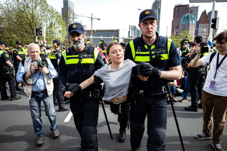 epa11262375 Swedish climate activist Greta Thunberg (C) is detained by police officers during a climate demonstration blocking the A12 highway in The Hague, The Netherlands, 06 April 2024. Thunberg joined the 37th highway blockade called by the Extinction Rebellion as new international actions against fossil subsidies were announced during the action. EPA/RAMON VAN FLYMEN
