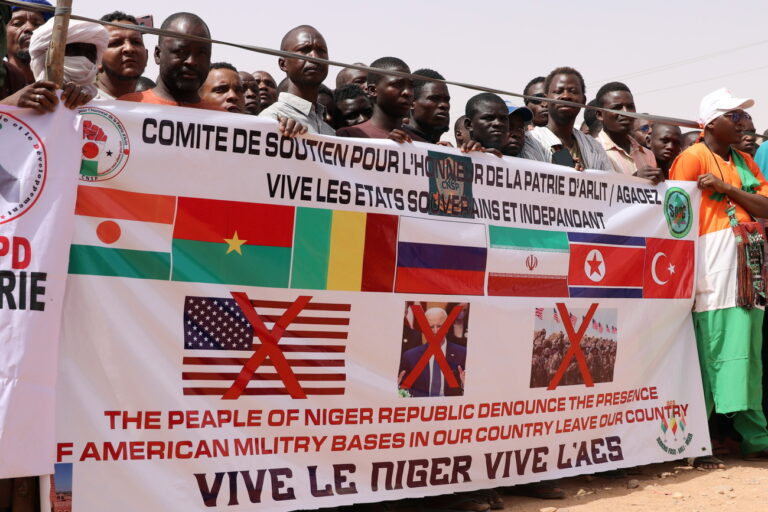 epa11291930 Demonstrators hold a banner during a protest rally to demand the withdrawal of US troops from Niger, in Agadez, Niger, 21 April 2024. In March 2024, the ruling military junta revoked a military agreement with the US. Niger's decision to oust the US military out of the country follows France's withdrawal of its forces from Niger last year. EPA/ISSIFOU DJIBO
