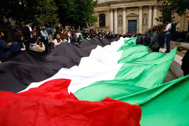 epa11308691 Pro-Palestinian demonstrators carry a huge Palestinian flag as they gather outside the Sorbonne University, where they tried to set up a protest camp before being evacuated by police in Paris, France, 29 April 2024. More than 34,300 Palestinians and over 1,455 Israelis have been killed, according to the Palestinian Health Ministry and the Israel Defense Forces (IDF), since Hamas militants launched an attack against Israel from the Gaza Strip on 07 October 2023, and the Israeli operations in Gaza and the West Bank which followed it. EPA/MOHAMMED BADRA