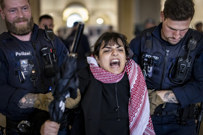 Police officers carry away a Pro-Palestinian demonstrator during protest in the entrance hall of the main building of the ETH Zurich on Tuesday, May 7, 2024 in Zurich, Switzerland. (KEYSTONE/Michael Buholzer)