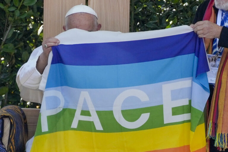 Pope Francis holds a peace flag during the 