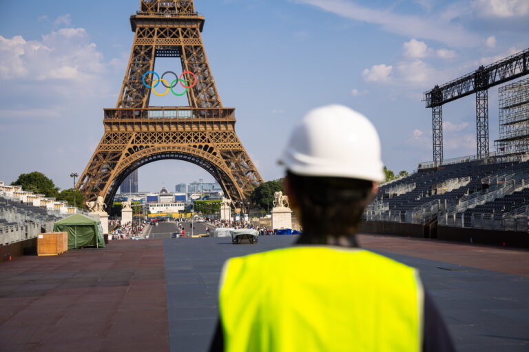 epa11439908 The Eiffel tower decorated with the Olympic rings seen from the working site of the opening ceremony at the Trocadero in Paris, France, 26 June 2024. The opening ceremony of the Paris 2024 Olympic Games will begin with a nautical parade on the Seine and ends on the protocol stage in front of the Eiffel Tower on 26 July 2024. EPA/CHRISTOPHE PETIT TESSON