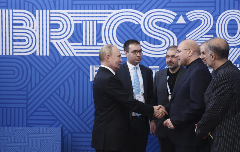 Russian President Vladimir Putin, left, and Iranian Parliament speaker Mohammad Bagher Ghalibaf, 2nd right, shake hands during their meeting on the sidelines of the BRICS Parliamentary Forum in St. Petersburg, Russia, Thursday, July 11, 2024. (Valeriy Sharifulin, Sputnik, Kremlin Pool Photo via AP)