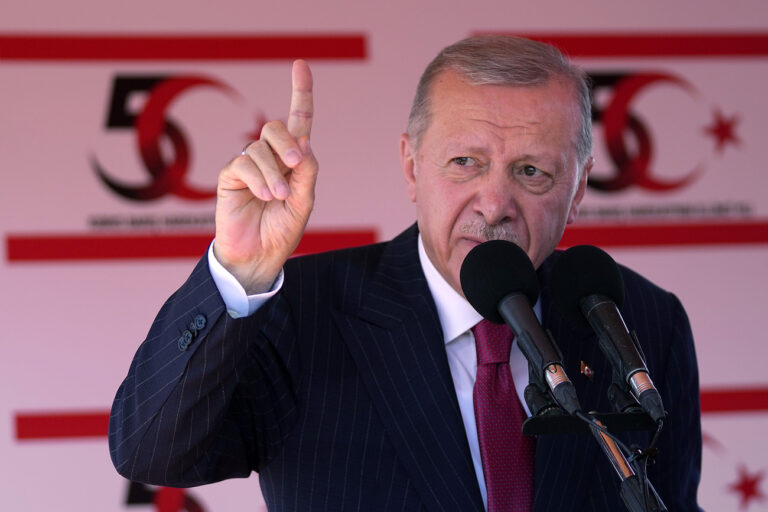 Turkish President Recep Tayyip Erdogan talks during a military parade, in the Turkish occupied area of the divided capital Nicosia, Cyprus, Saturday, July 20, 2024. (AP Photo/Petros Karadjias)