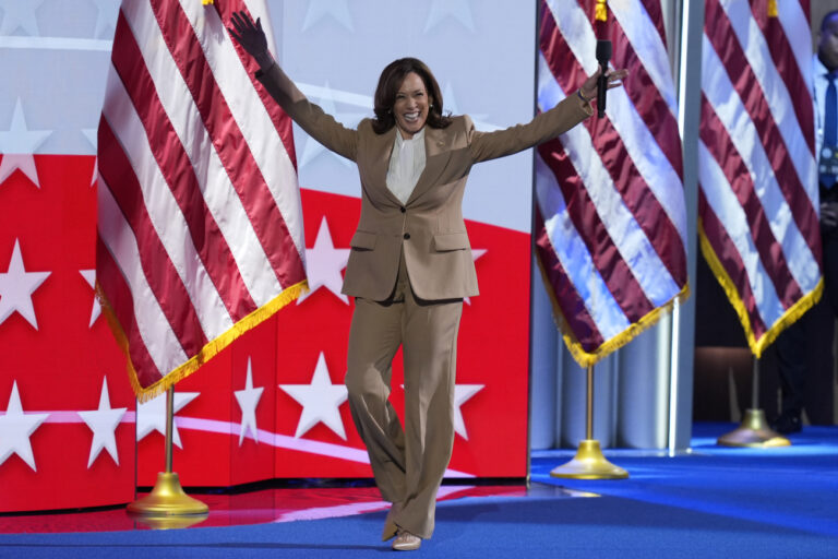 Democratic presidential nominee Vice President Kamala Harris raises her arms as she walks on stage during the Democratic National Convention Monday, Aug. 19, 2024, in Chicago. (AP Photo/J. Scott Applewhite)