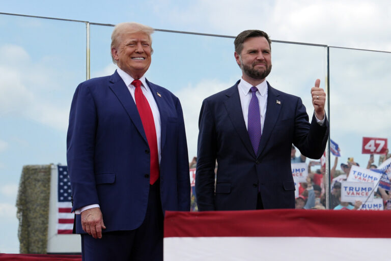 Republican presidential nominee former President Donald Trump and Republican vice presidential nominee Sen. JD Vance, R-Ohio, stand on stage at a campaign rally at North Carolina Aviation Museum, Wednesday, Aug. 21, 2024, in Asheboro, N.C. (AP Photo/Julia Nikhinson)