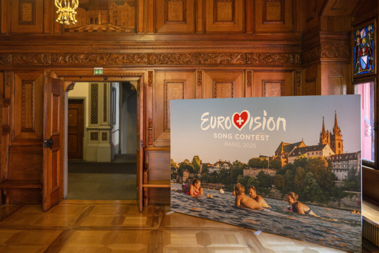 A poster with the Eurovision Song Contest (ESC) logo stands in the town hall as the press conference on the staging of the ESC 2025 takes place, in Basel, on Friday, August 30, 2024. The ESC 2025 will be held in Basel. This was announced today by the SRG. (KEYSTONE/Georgios Kefalas)